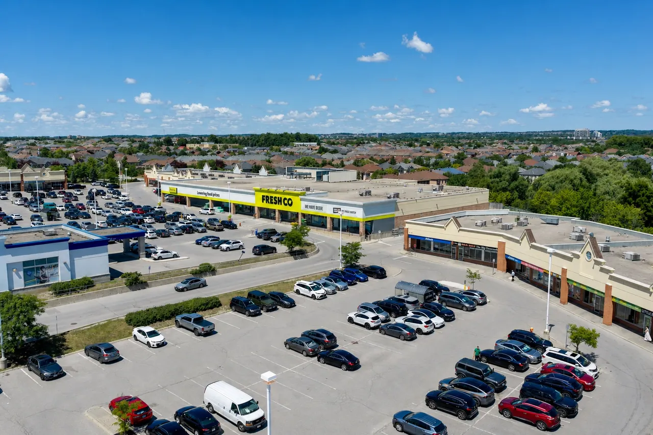 Aerial view of a retail plaza and its parking lot