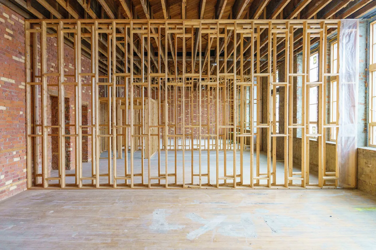 Interior with exposed timber framing against a brick wall